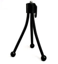 Small black iron mini tripod with ball head extended, next to an iPhone on a desk