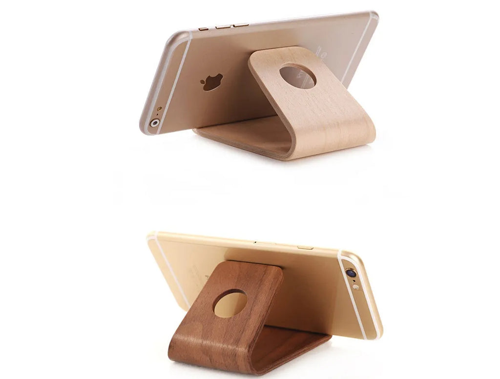 Wooden desk stand holding an iPhone, shown in walnut and white maple wood finishes.