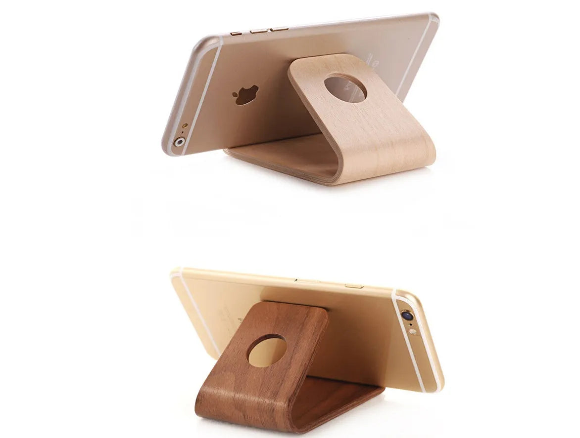 Wooden desk stand holding an iPhone, shown in walnut and white maple wood finishes.