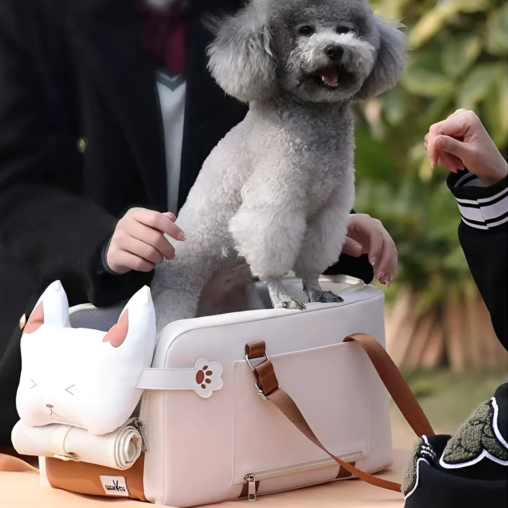 Beige hard-shell portable cat carrier flight case with one-shoulder strap, dimensions 43cm by 25cm by 22.5cm.