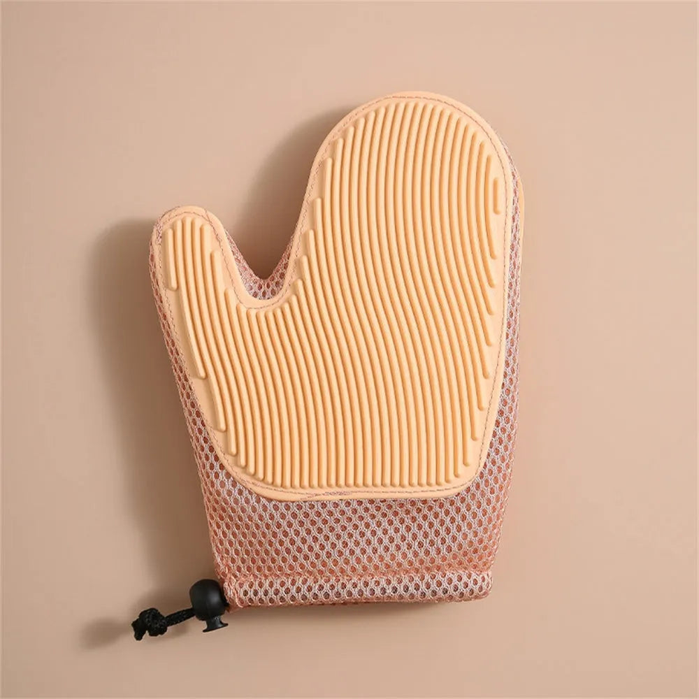 Dark blue pet hair removal grooming glove for right hand on a fabric sofa.