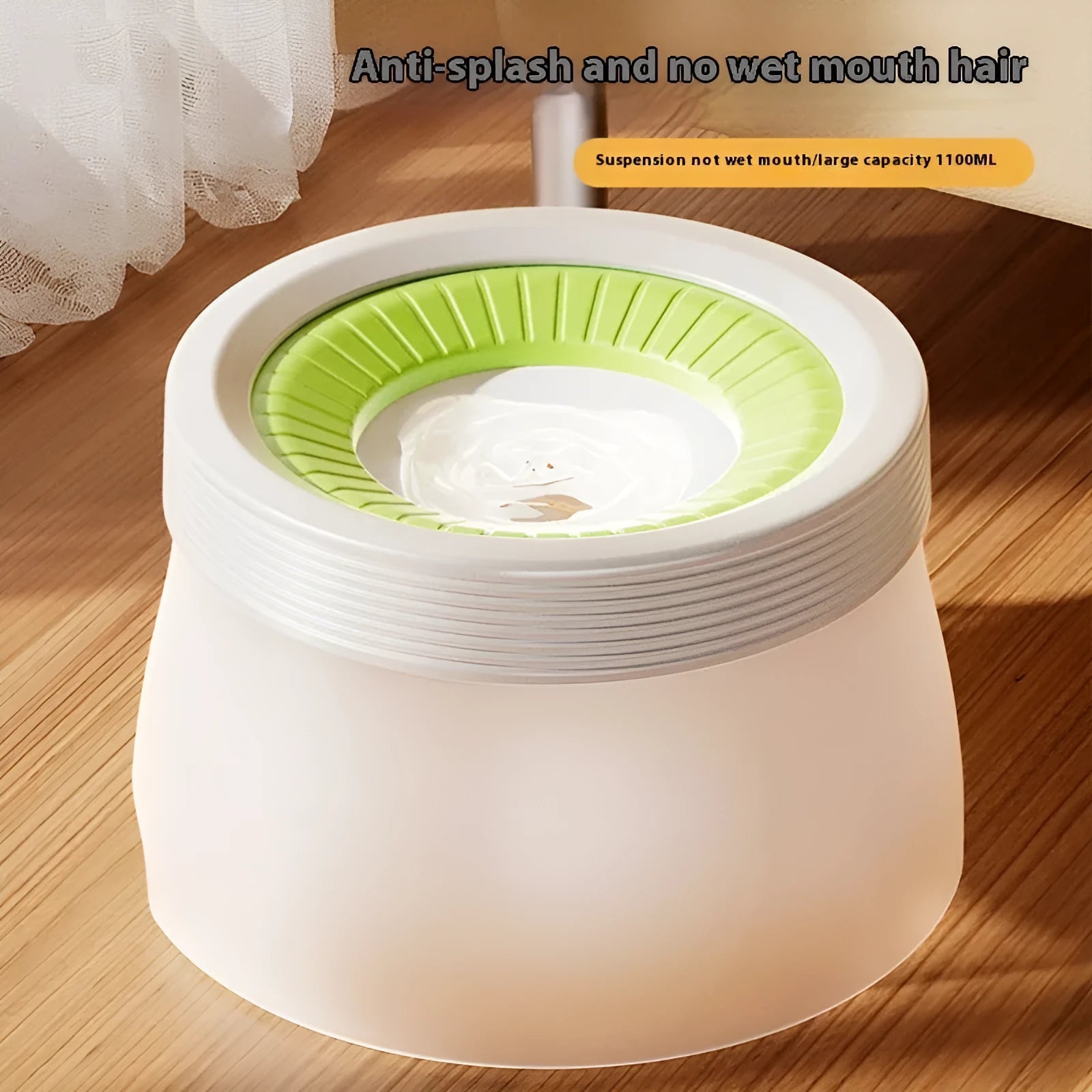 Green elevated pet water bowl with suspension stand next to a drinking cat