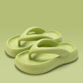 Women's solid colour EVA flip-flops with a thick sole and a bow detail on the upper.