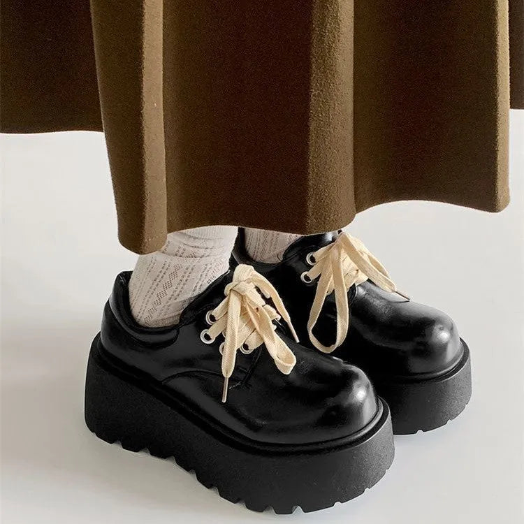 Women's matte black retro chunky sole lace-up ankle boots with a round toe on a white background.
