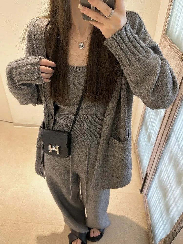 Women's light brown knit cardigan three-piece set with suspender casual pants on a hanger.