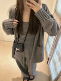 Women's light brown knit cardigan three-piece set with suspender casual pants on a hanger.