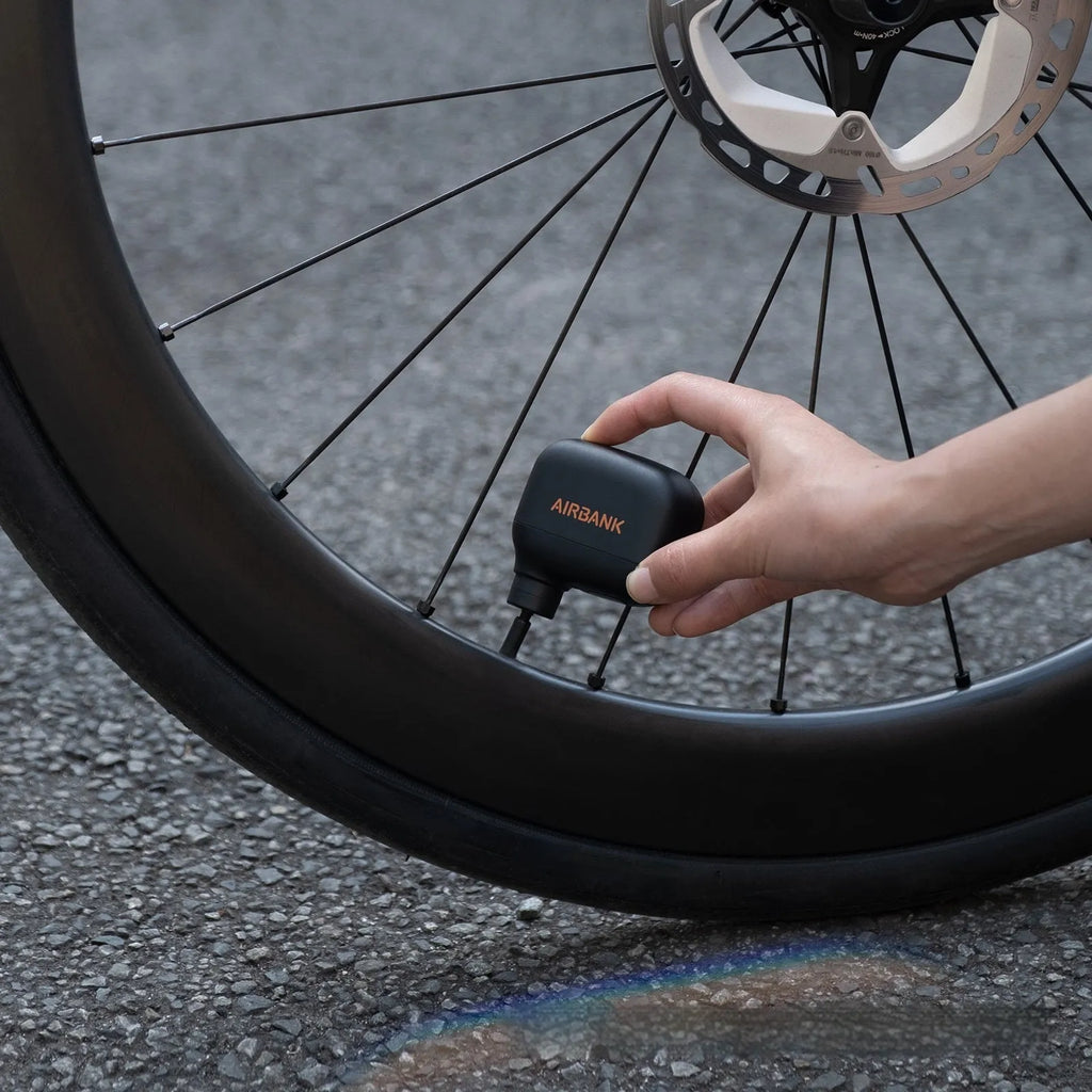 Black mini electric bicycle pump with USB cable and waterproof bag