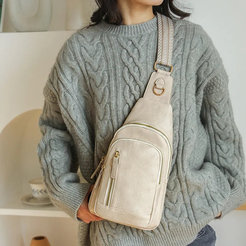 Women's soft PU leather chest bag with crossbody strap and organised interior compartments