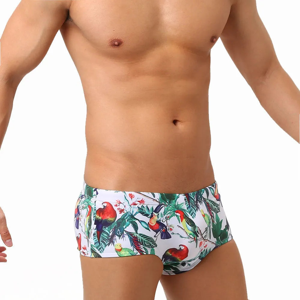 Men's floral bird print swimming trunks in nylon fabric, shown in small boxer style.