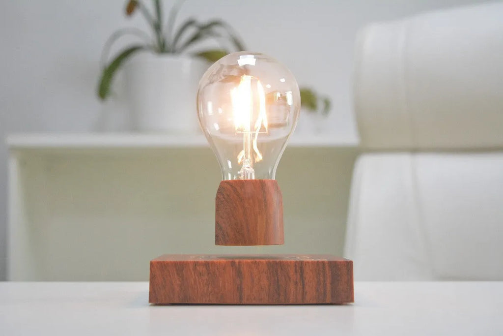 Magnetic levitation light bulb with imitation wood base on table.
