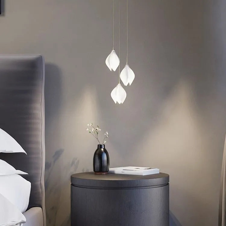 Ceramic magnolia flower-shaped single head pendant chandelier light with a dimmable bulb.