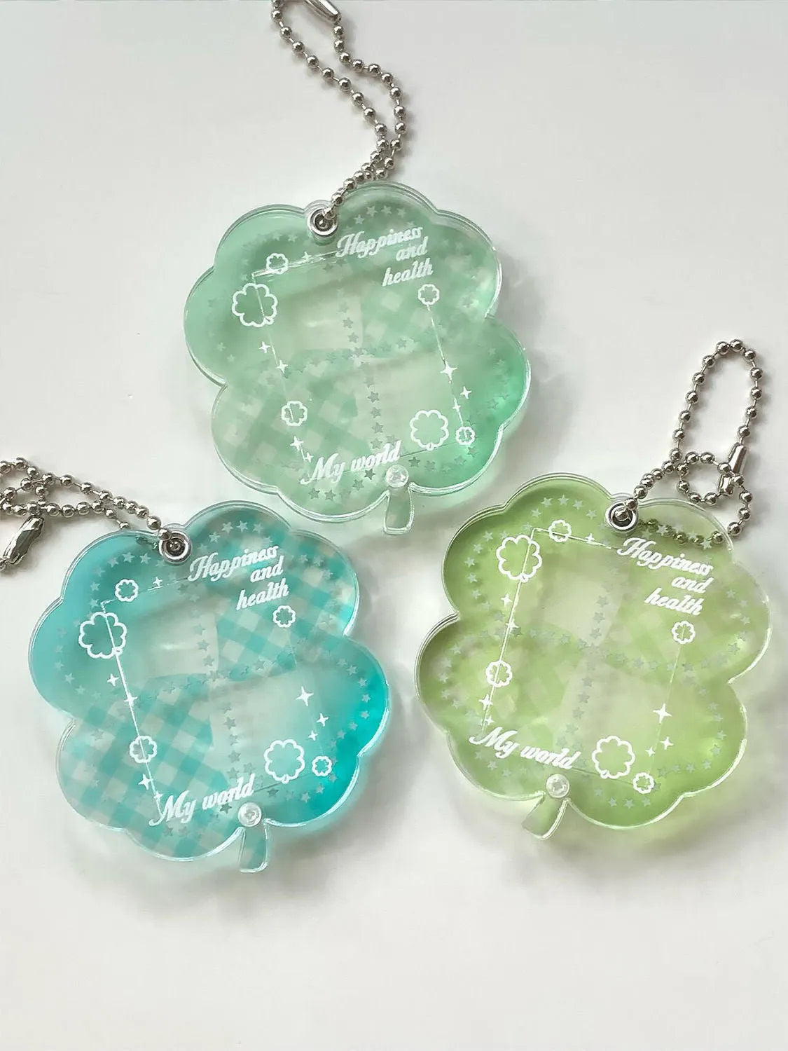 Acrylic four-leaf clover phone pendant keychain in blue, green, or mint green.