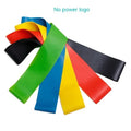 Set of five coloured yoga resistance bands with force markings arranged by thickness from thinnest to thickest