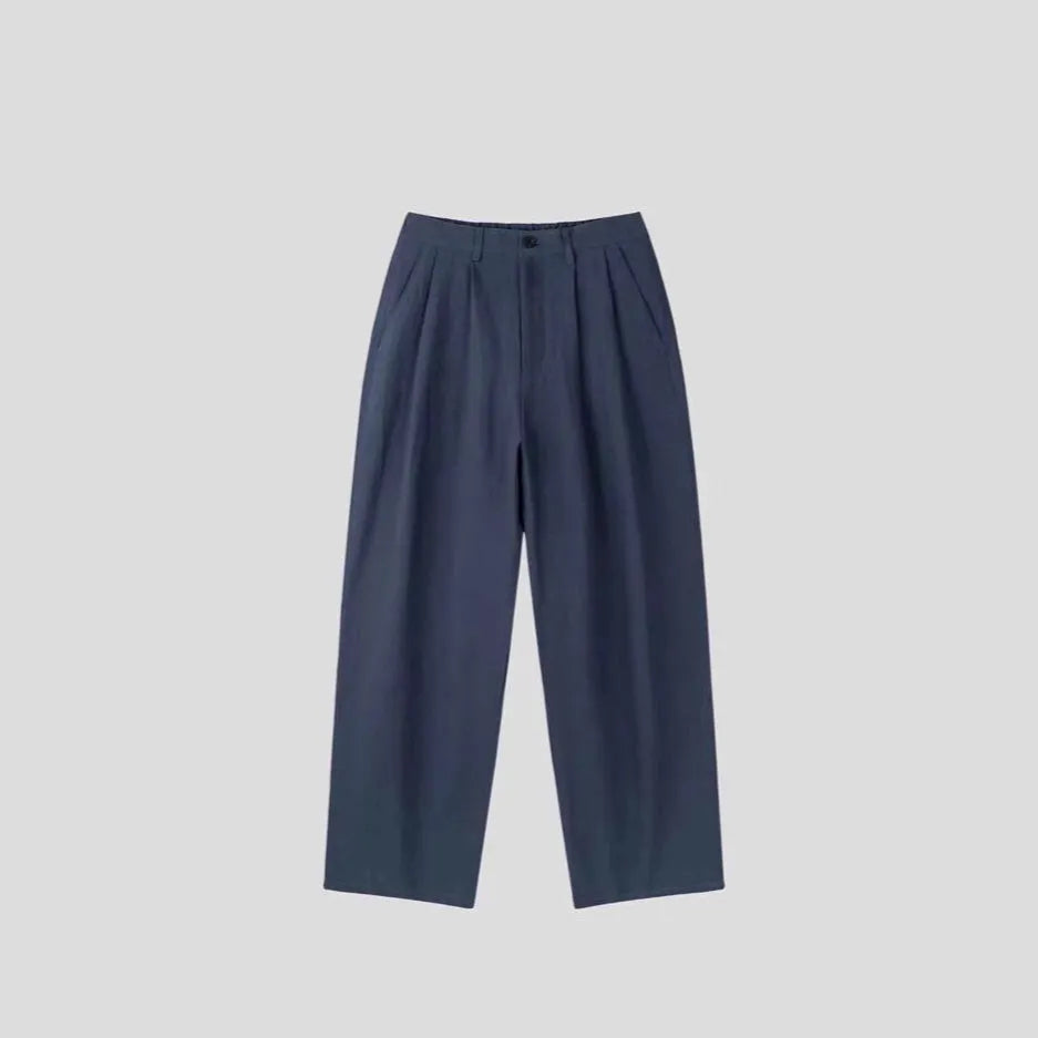 Men's light-weight apricot coloured cotton linen trousers with a loose Korean fit and pencil leg opening.