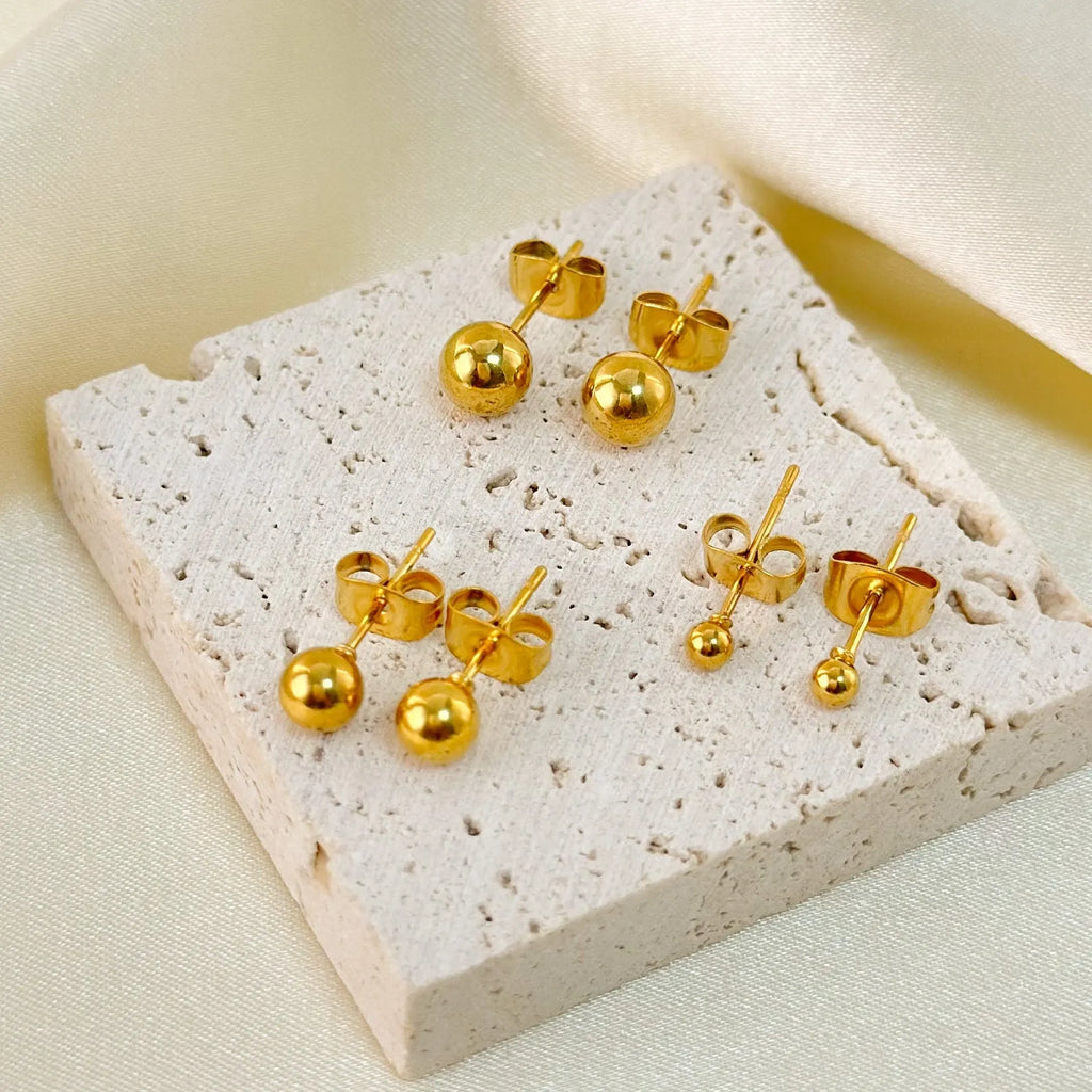 Stainless steel minimalist ball stud earrings in gold or silver, showing size comparison of 3mm, 4mm, 5mm and 6mm balls.