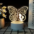 Modern white heart-shaped table lamp with acrylic shade on a wooden surface.