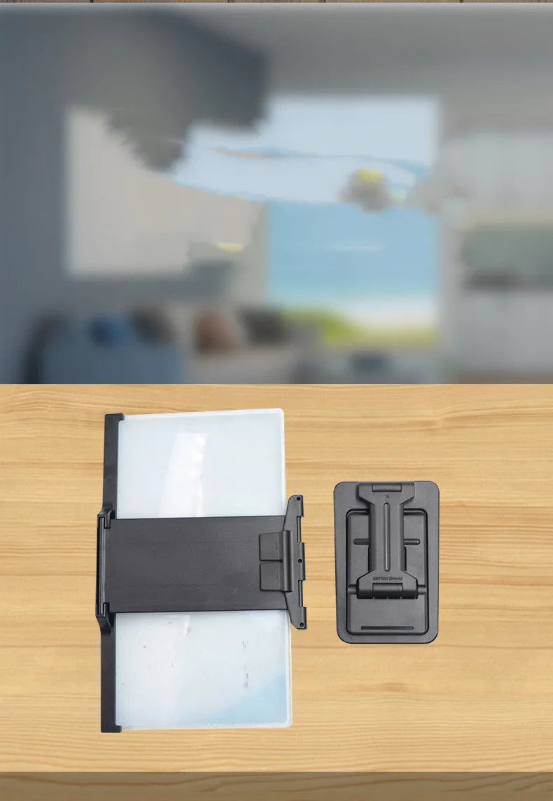Black folding mobile phone screen amplifier with detachable holder showing 3-4x magnification