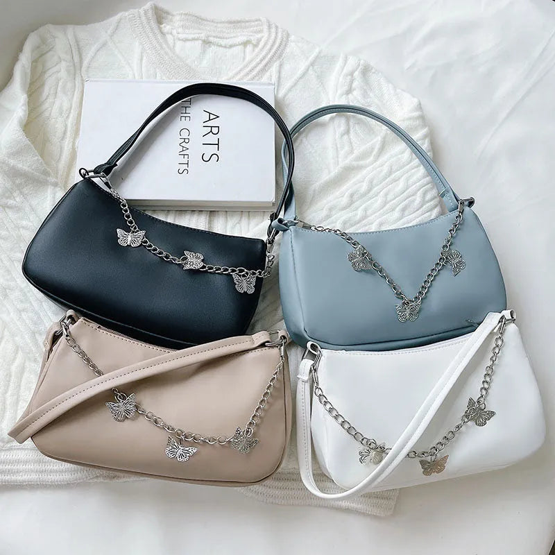 Horizontal square PU leather crossbody bag with butterfly chain detailing in light blue colour