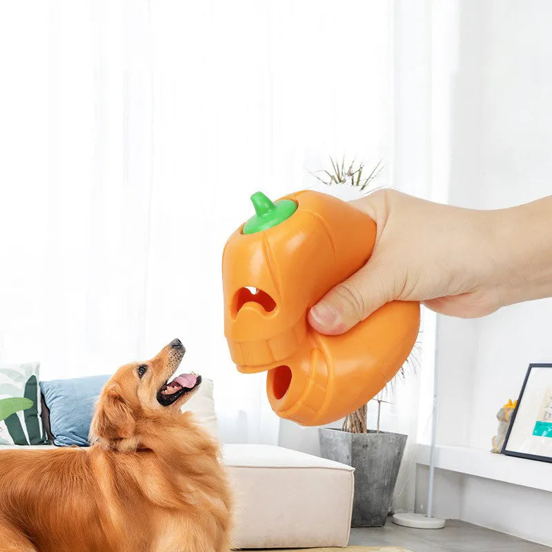 Orange Halloween pumpkin shaped durable rubber dog toy with a treat-dispensing funnel opening.