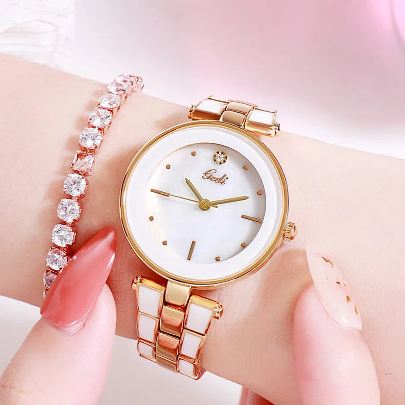 Ladies quartz watch with white round dial, steel strap, and rose gold sheen on a plain background