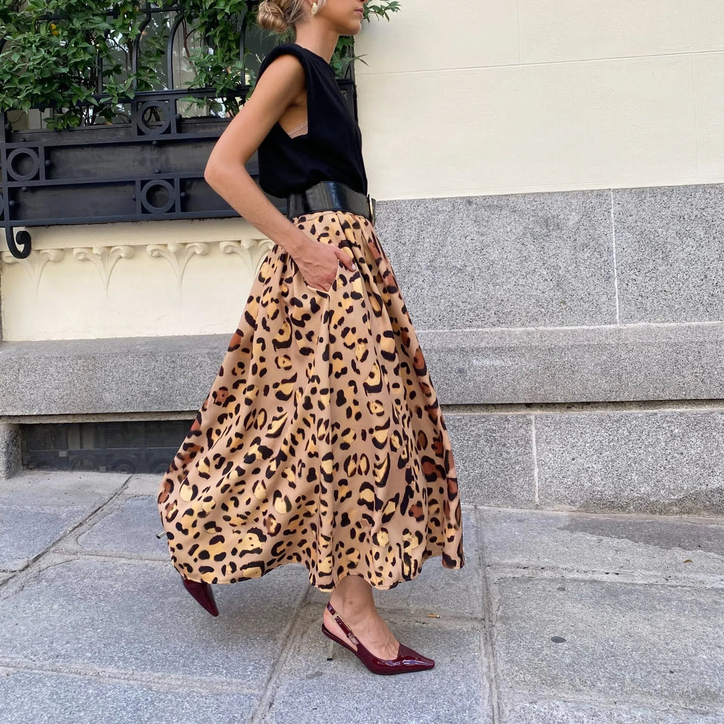 Brown leopard print women's A-line long skirt with a large hemline, shown on a model.