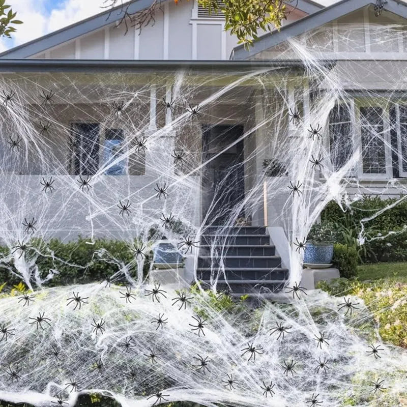 White cotton spider web Halloween decoration with plastic spiders for parties and home displays