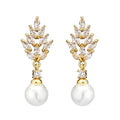 Geometric flower design pearl earrings with micro inlaid zircon stones in gold, platinum, or rose gold plated finishes.