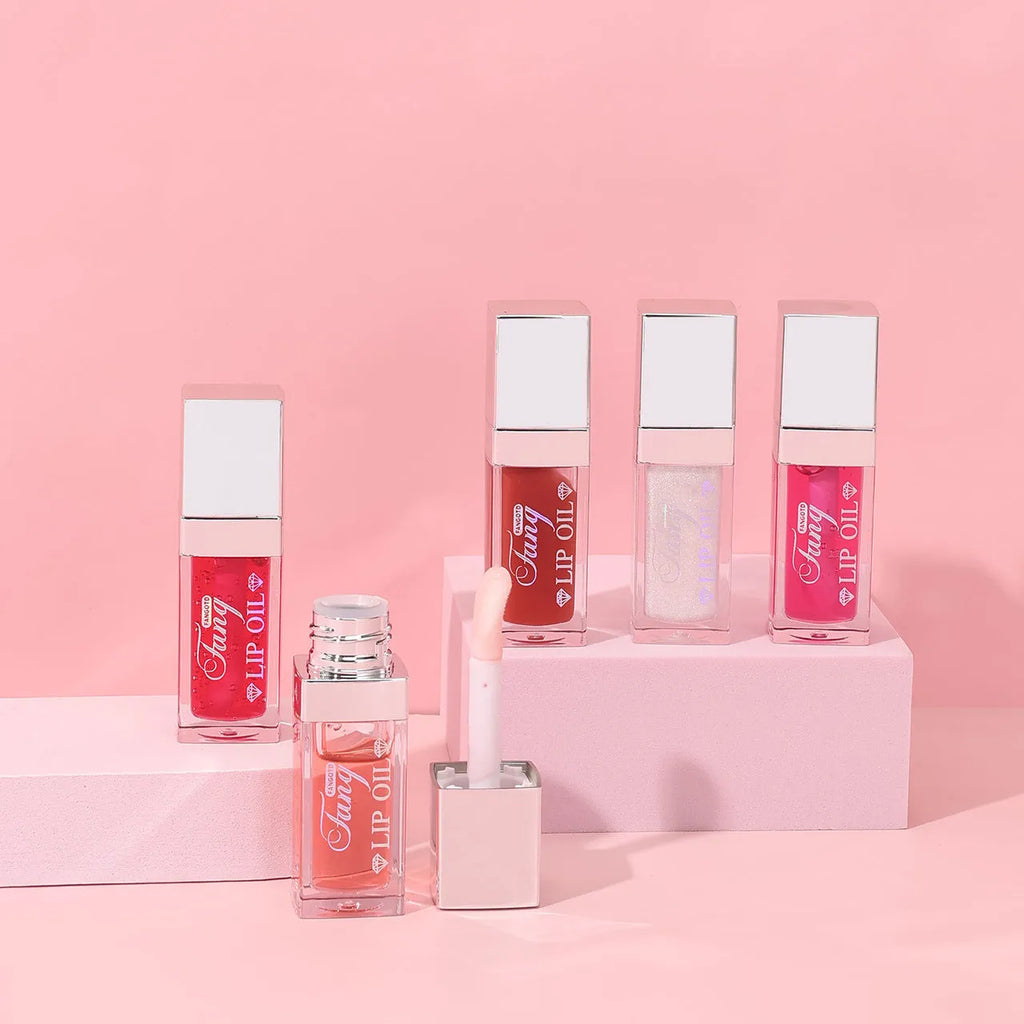 Mint lip gloss tube in one of five colours including bright pink, orange and dark red.