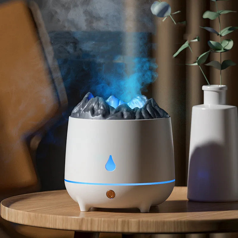 White volcano-shaped humidifier with flaming mountain design on wooden surface