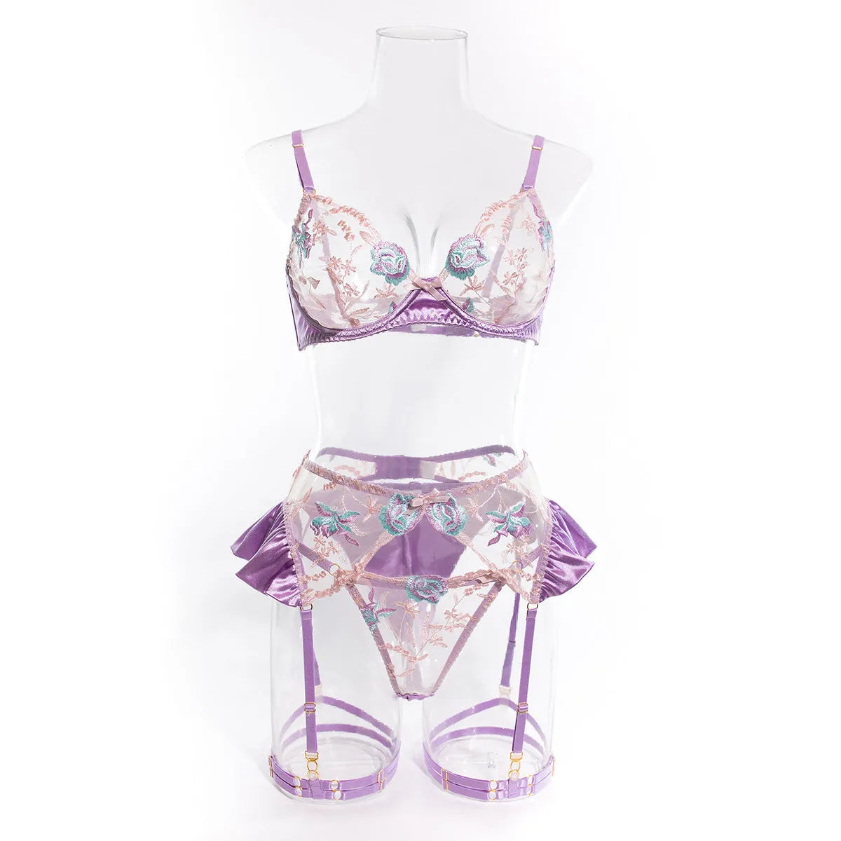 Light purple satin four-piece lingerie set with embroidery detail on a hanger.