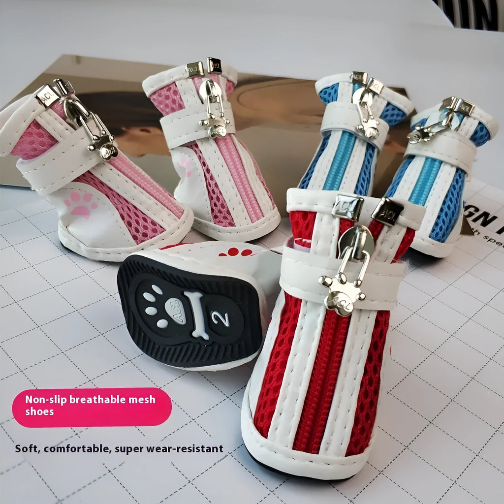 Four blue cloth dog shoes with zipper closures and non-slip soles arranged together