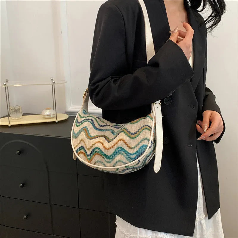 Women's straw woven crossbody bag showing internal phone and file compartments