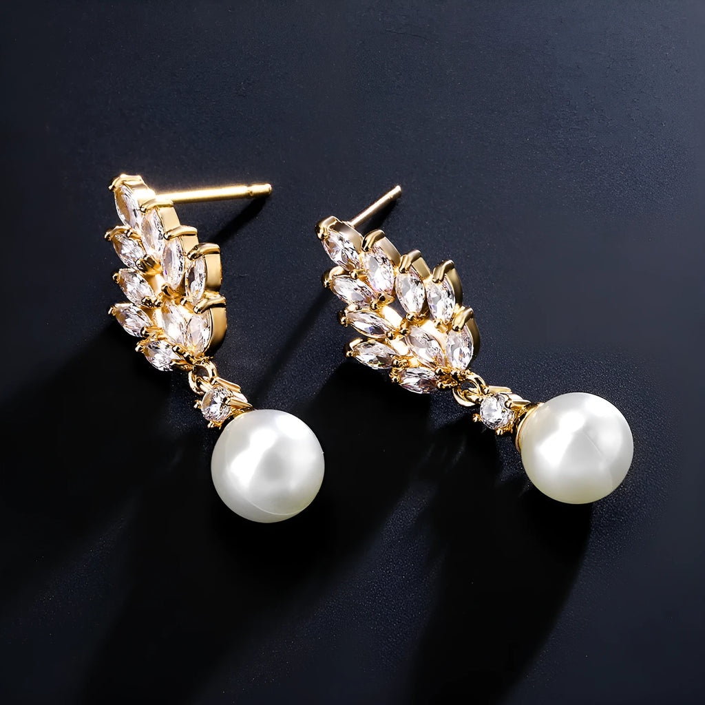 Geometric flower design pearl earrings with micro inlaid zircon stones in gold, platinum, or rose gold plated finishes.