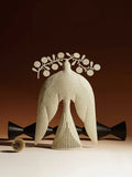 Handmade iron flying bird ornament in traditional Chinese style on a wooden surface.