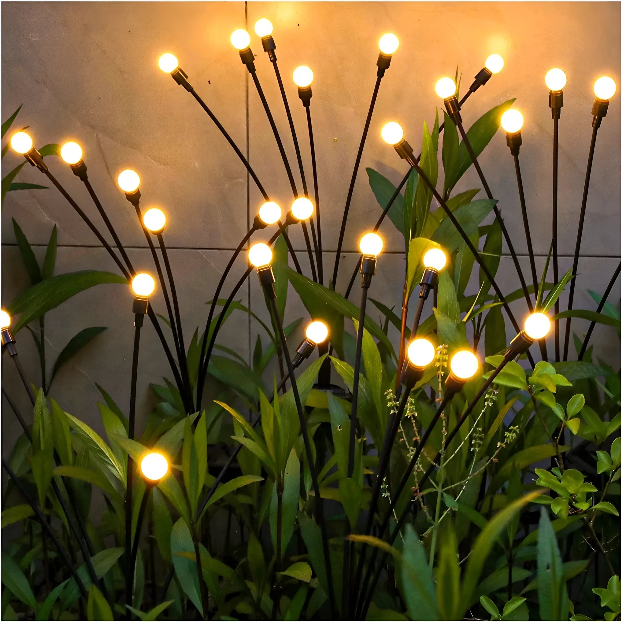 Solar-powered LED garden ground light with multiple heads and a stainless steel stake inserted into soil.