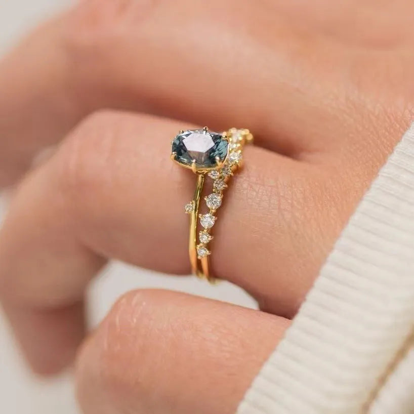 Gold plated women's ring with flower design and green zircon stones showing five available ring sizes