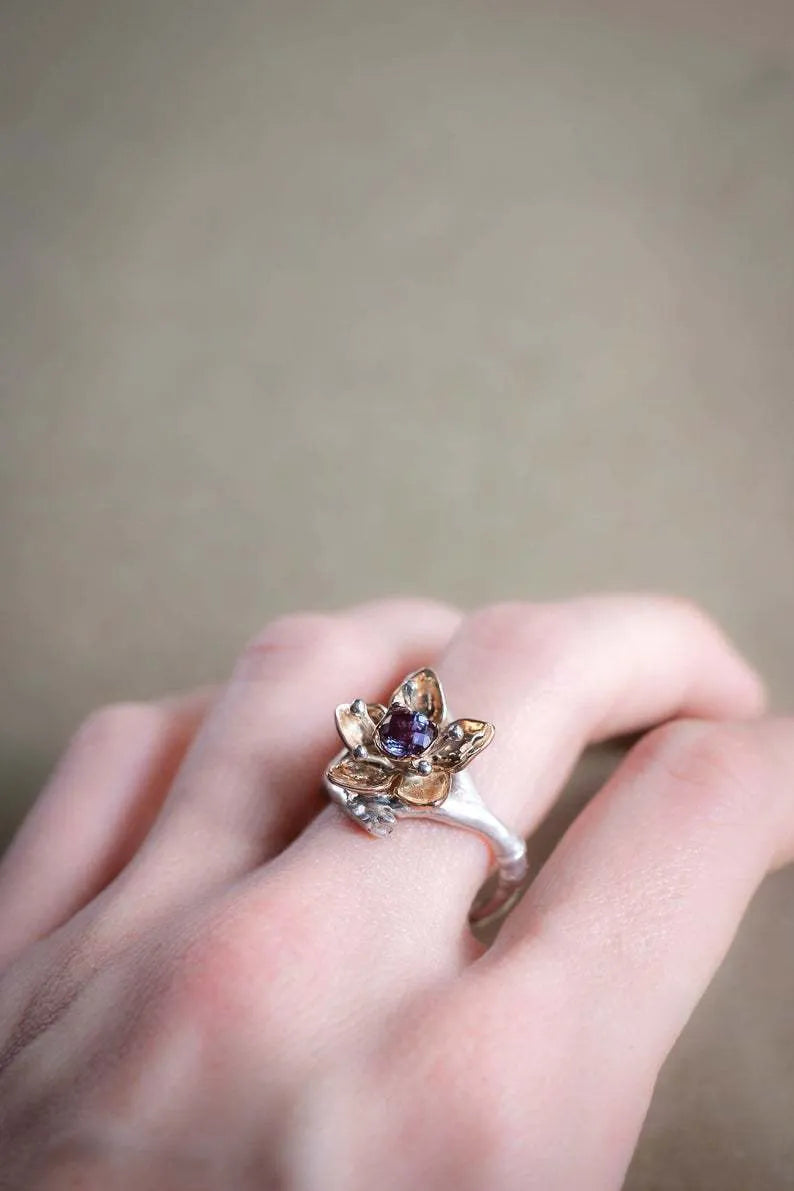 Women's two-tone floral alloy ring in silver on a light background, geometric shape, ornamental design