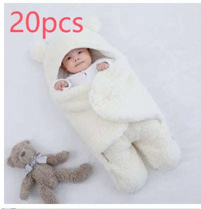 Baby quilted sleeping bag wrapper in cotton blend fabric, shown in grey colour with size tag.