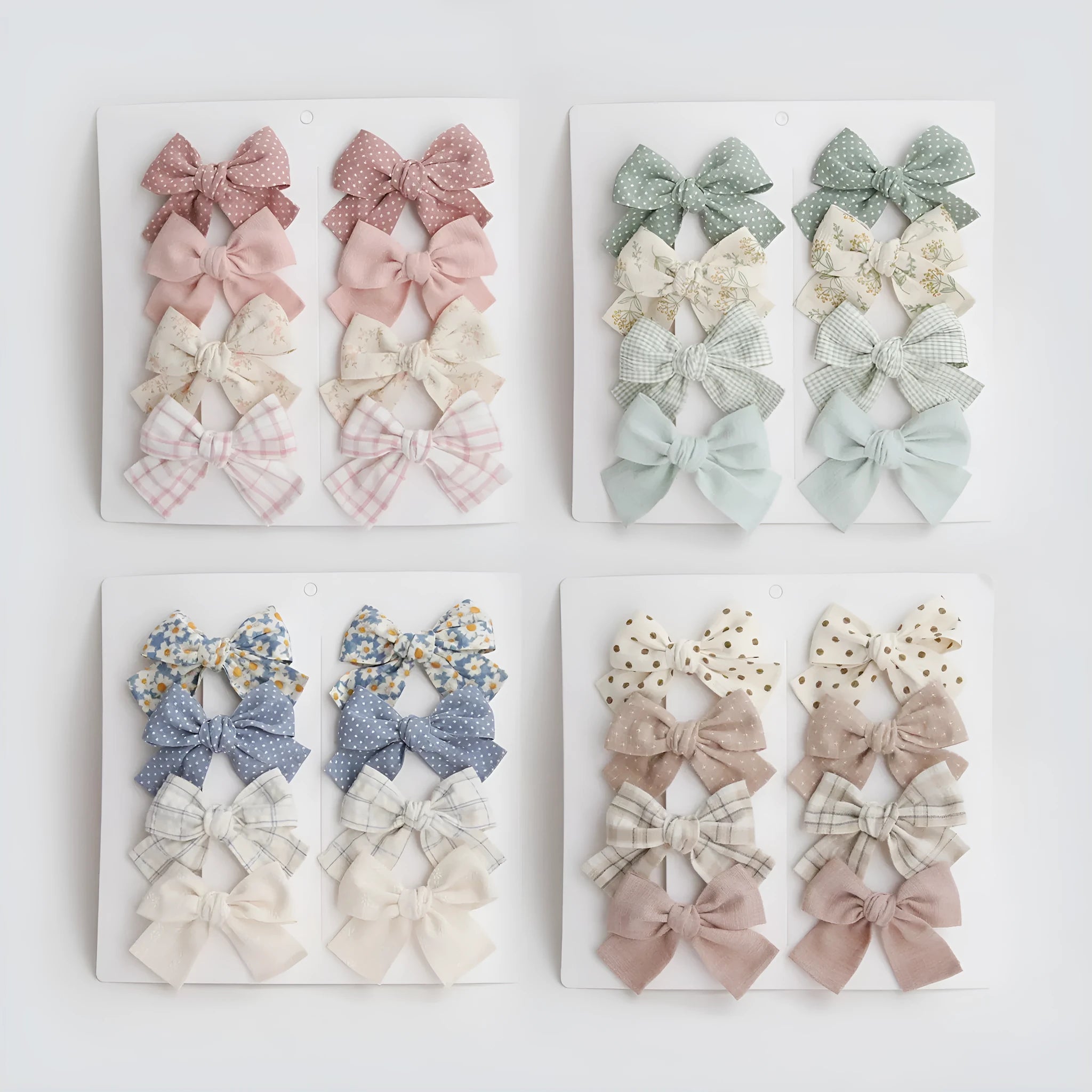 Set of children's fabric hairclips with dovetail bows in eight different colours and patterns.