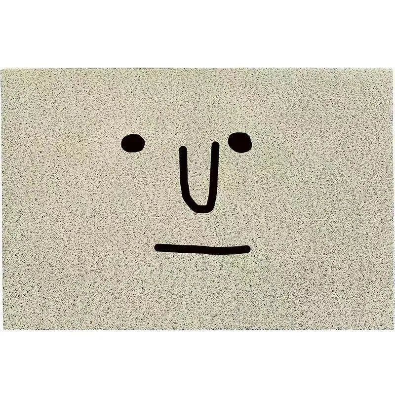 Square PVC floor mat with a geometric cartoon face pattern in Mr Big Nose colours.