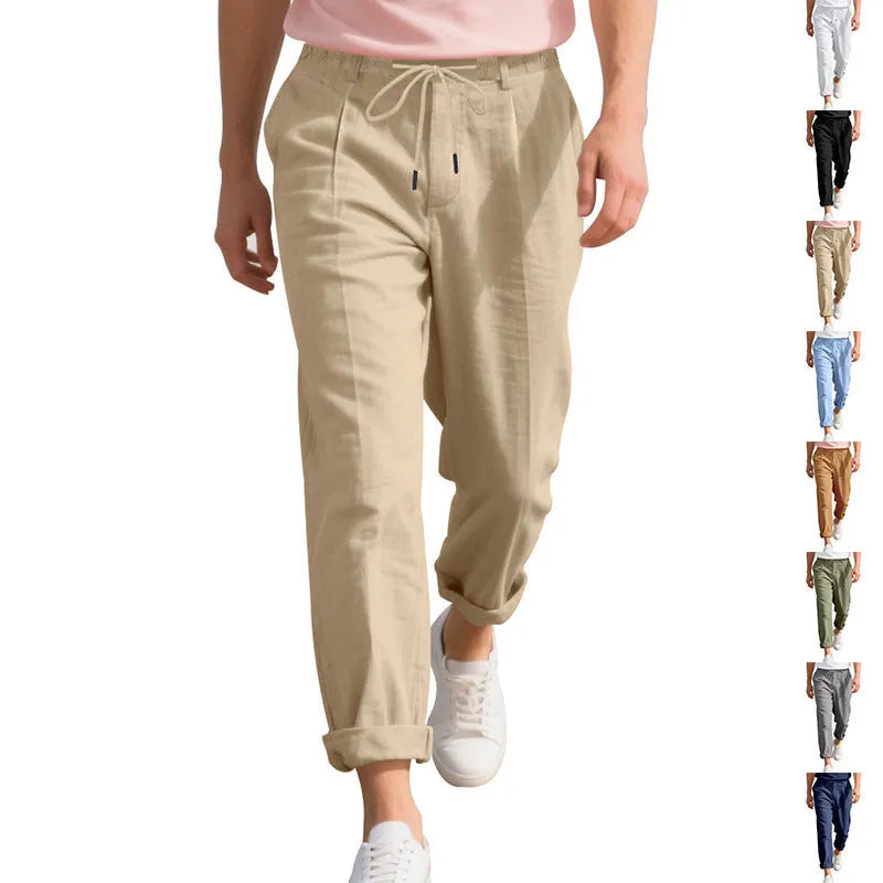 Man wearing light khaki linen casual trousers with a drawstring waist and straight leg.
