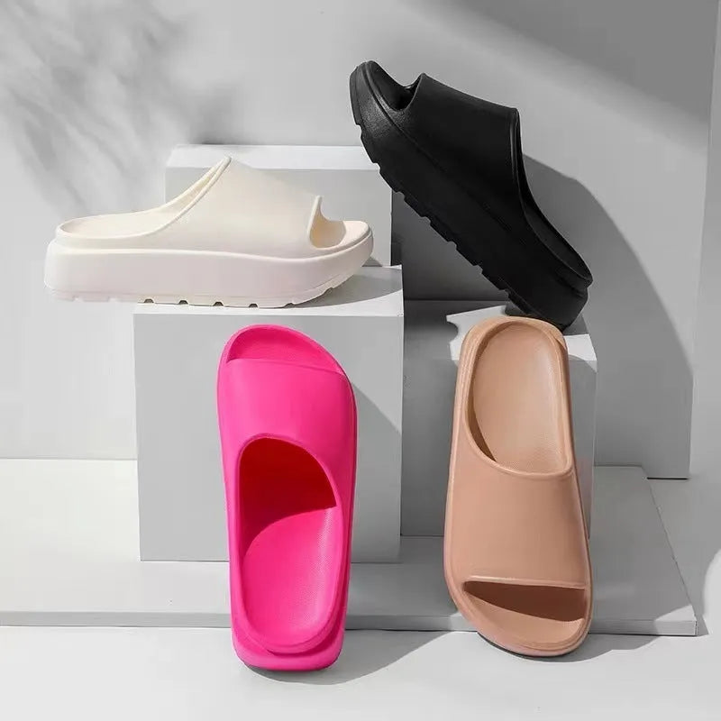 Women's beige fish mouth slippers with a thick 5.5cm EVA platform sole on a wooden floor.