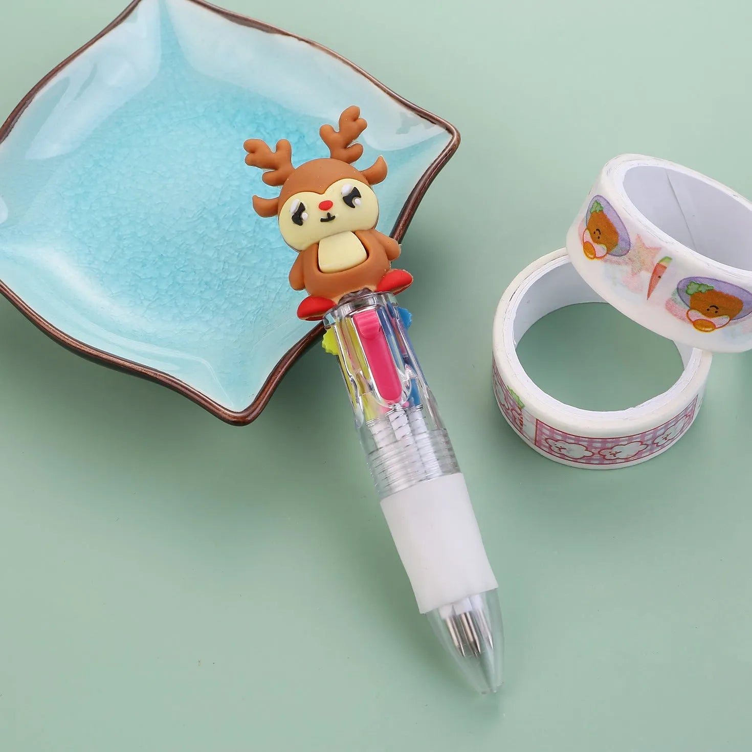 Christmas mini four-colour press-type ballpoint pen showing festive designs, 11cm long.