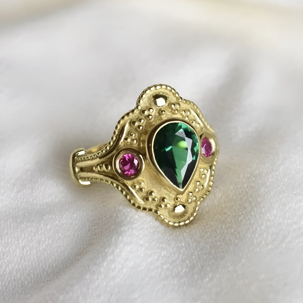 Women's geometric fashion ring in golden lvzuan colour on a grey background.