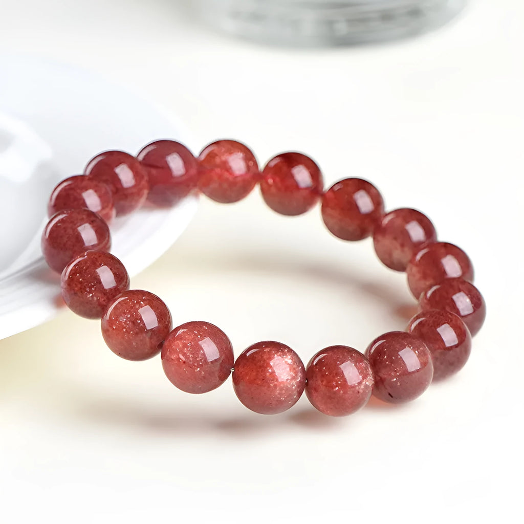 Natural starlight cherry red strawberry quartz bracelet with geometric beads on wrist