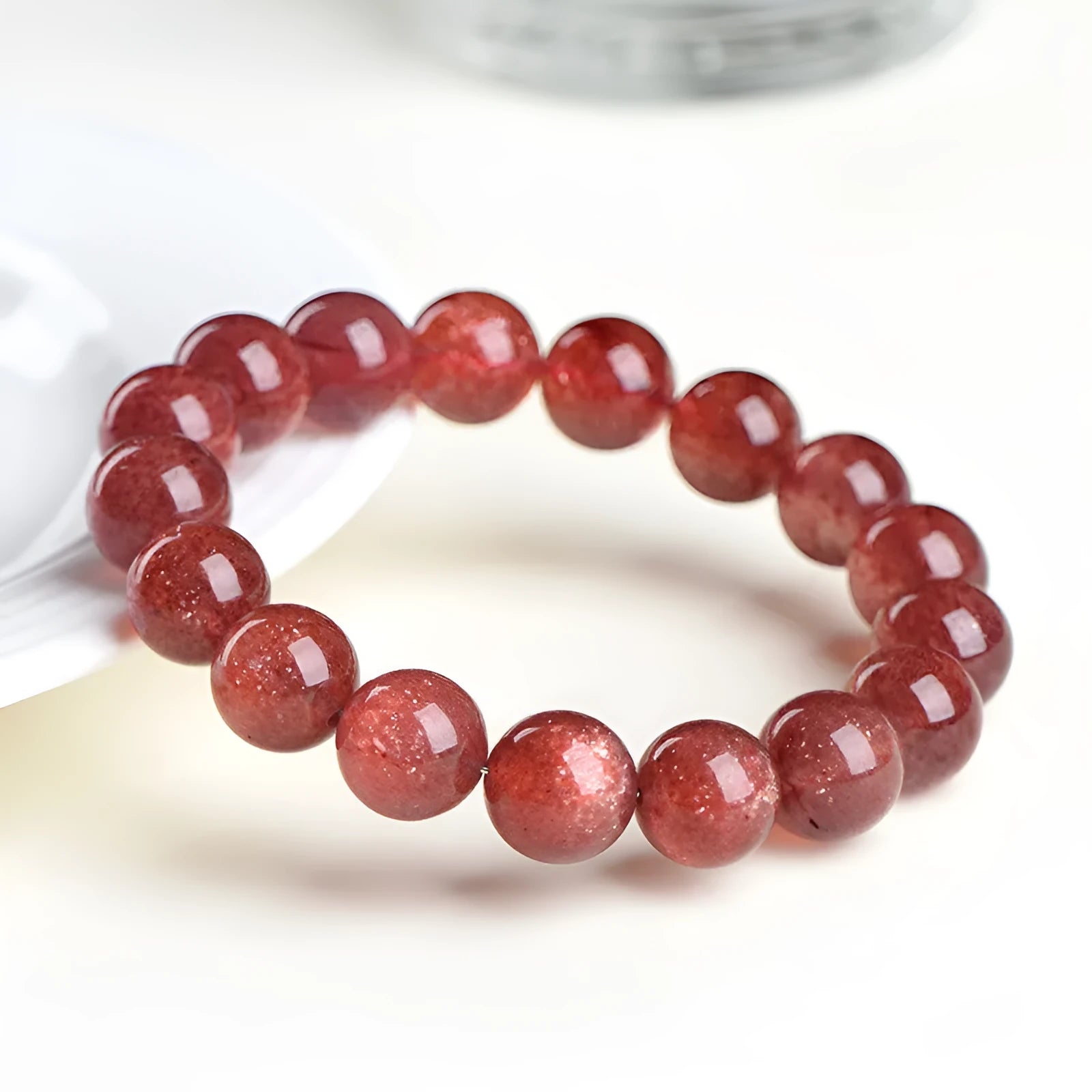 Natural starlight cherry red strawberry quartz bracelet with geometric beads on wrist