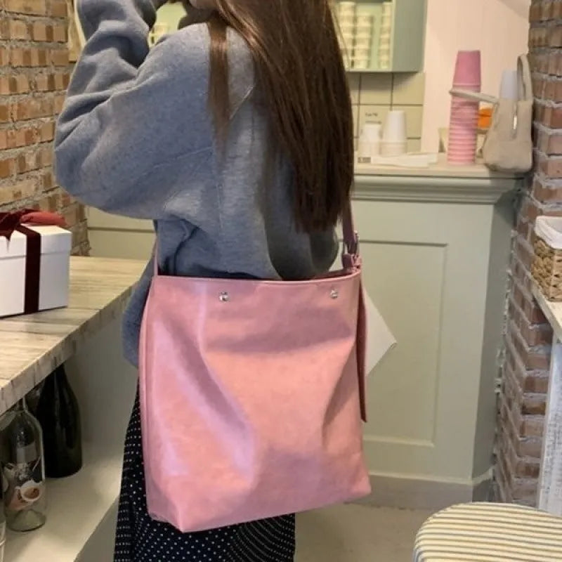 Corduroy one-shoulder commuter bag with pink or brown colour options showing 39cm length dimension