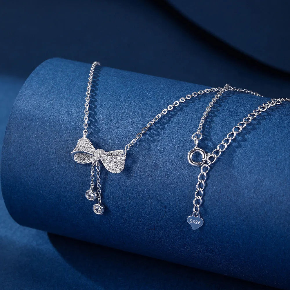 Silver bow pendant necklace on adjustable 40-45cm chain with O-ring closure