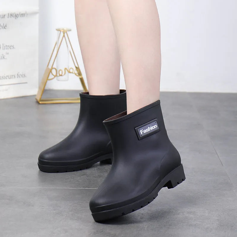 Women's mid-calf PVC rain boots in black colour with low heel