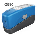 Handheld ceramic brightness stone portable glossiness tester gloss meter on a work surface.